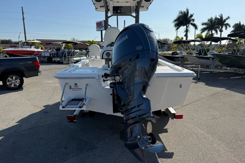 Slide: The Image of 2025 Sea Pro 210 Bay boat with Yamaha engine, featuring sleek design and fishing rod holders. - 9