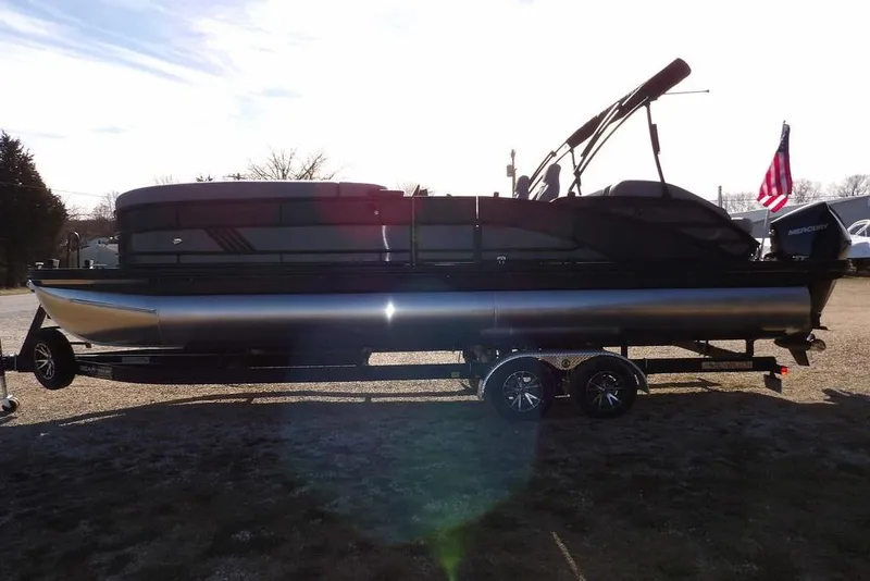 Slide: The Image of 2026 Bennington M Swingback 26 MSB pontoon boat on trailer, side view. - 10