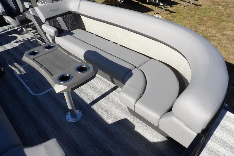 Slide: The Image of 2026 Bennington M Swingback 26 MSB boat interior with gray seating and cup holders. - 17