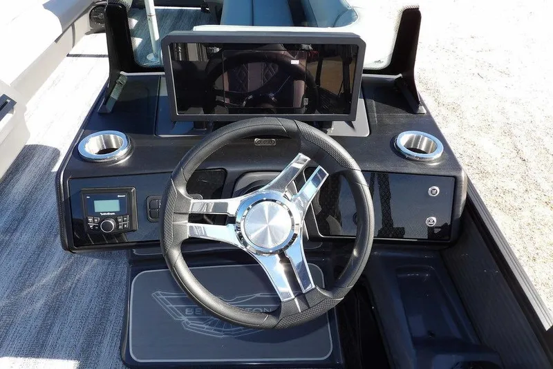 Slide: The Image of 2026 Bennington M Swingback 26 MSB boat dashboard with steering wheel and digital display. - 20
