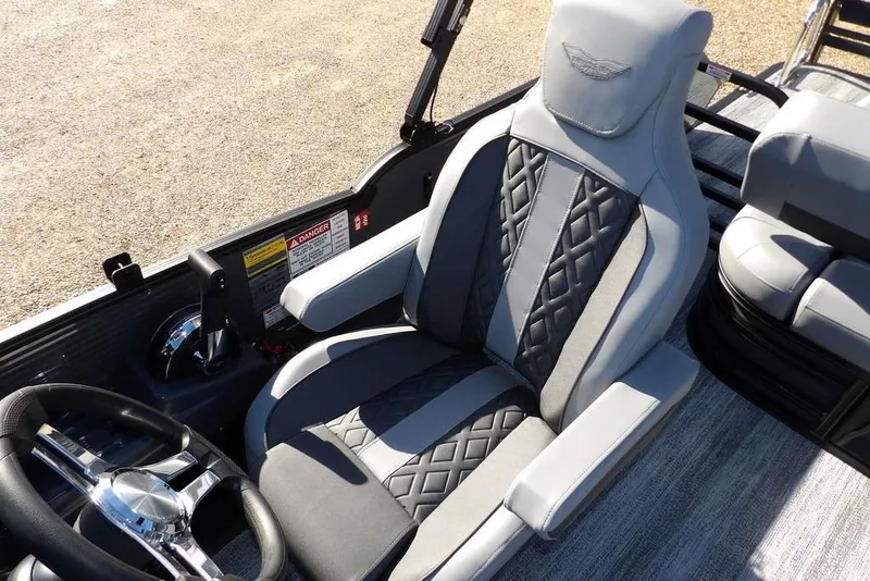 Slide: The Image of 2026 Bennington M Swingback 26 MSB boat interior with luxurious seating and steering wheel. - 25