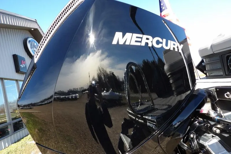 Slide: The Image of Mercury engine on 2026 Bennington M Swingback 26 MSB, reflecting sky and surroundings. - 43