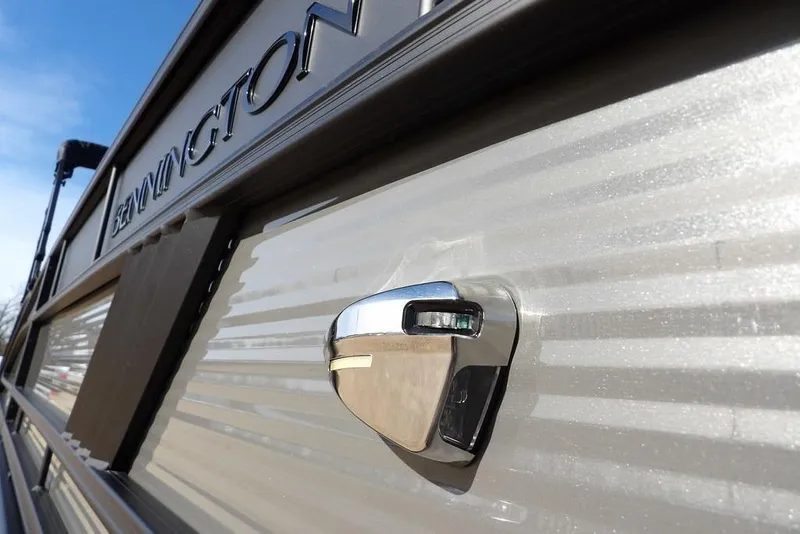 Slide: The Image of 2026 Bennington M Swingback 26 MSB boat detail with chrome accent and logo. - 44