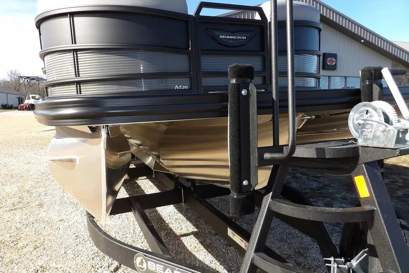 Slide: The Image of 2026 Bennington M Swingback 26 MSB pontoon boat on trailer, outdoor setting. - 50