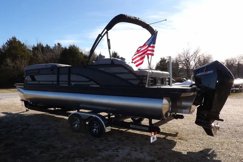 Slide: The Image of 2026 Bennington M Swingback 26 MSB pontoon boat with Mercury engine and American flag. - 6