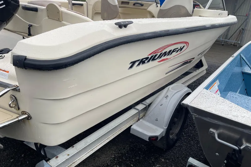 Slide: The Image of 2004 Triumph 191 Fish & Ski boat on trailer, dual console design, side view. - 4