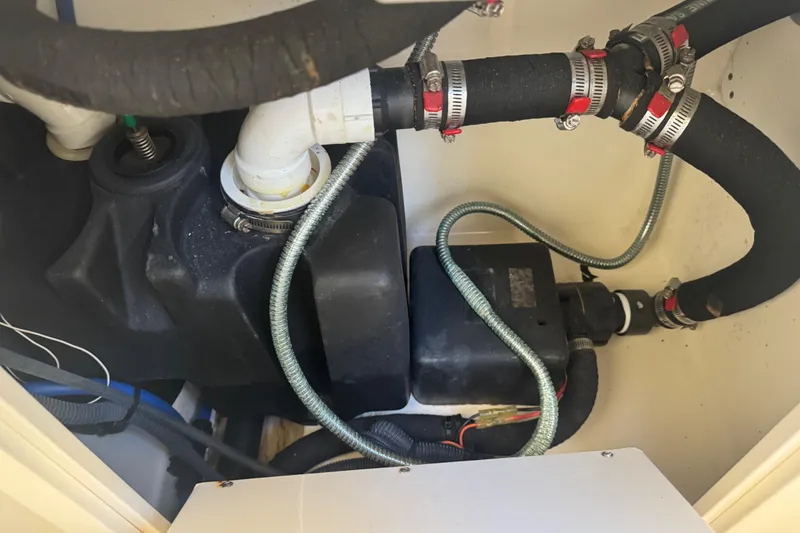 Slide: The Image of 2005 Boston Whaler 320 Outrage boat storage compartment open, showcasing interior features. - 16