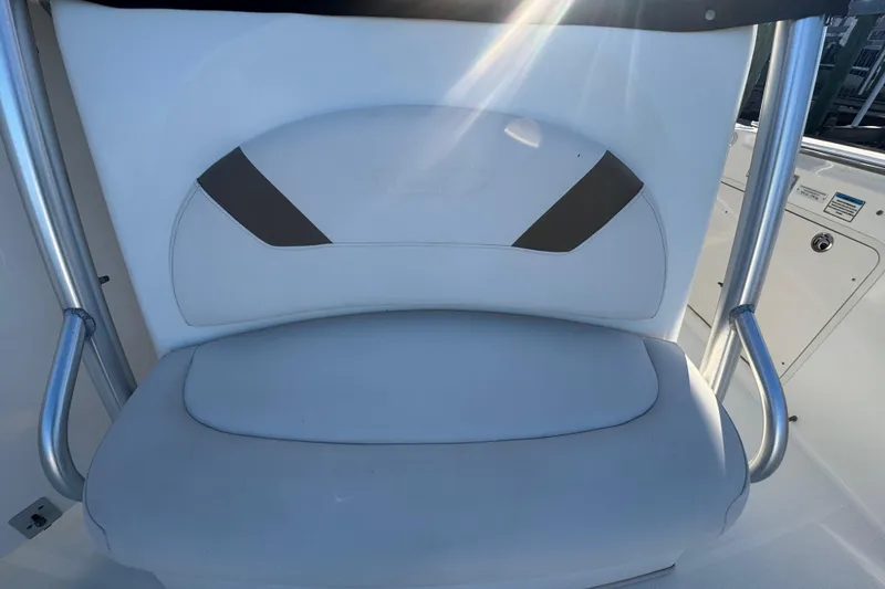 Slide: The Image of Twin Mercury outboard engines on a 2005 Boston Whaler 320 Outrage, docked by a wooden pier. - 19