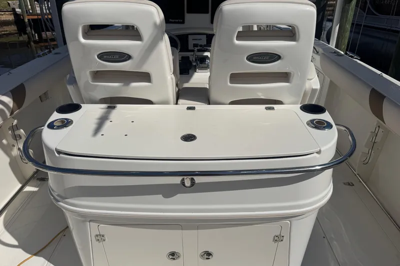 Slide: The Image of 2005 Boston Whaler 320 Outrage with twin 300 Verado engines docked by palm trees. - 20