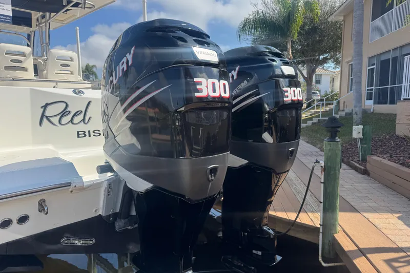 Slide: The Image of 2005 Boston Whaler 320 Outrage boat docked under sunny sky with palm trees. - 24