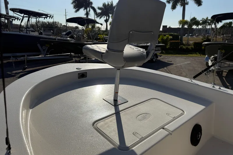 Slide: The Image of 2026 Carolina Skiff E18 JVX CC boat with swivel seat and storage compartment. - 11