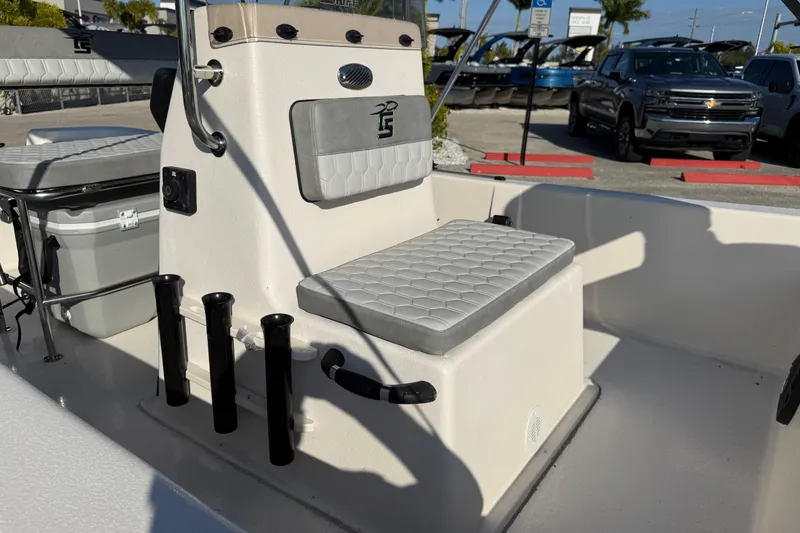 Slide: The Image of 2026 Carolina Skiff E18 JVX CC boat interior with cushioned seating and rod holders. - 18