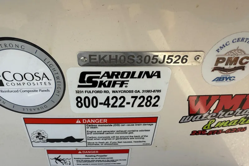 Slide: The Image of 2026 Carolina Skiff E18 JVX CC boat with safety and manufacturer labels. - 19