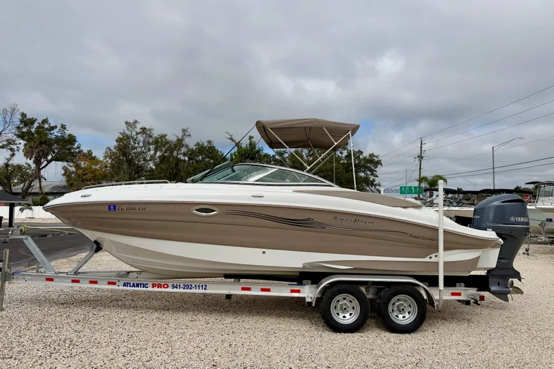 The Image of 2012 SouthWind 2600 SD boat on trailer, parked outdoors under cloudy sky. - 0