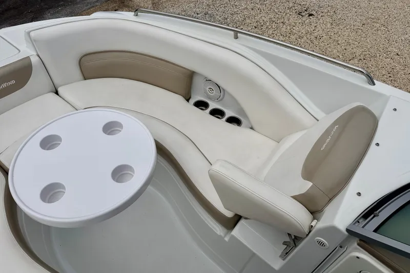 Slide: The Image of 2012 SouthWind 2600 SD boat interior with beige seating and round table. - 11
