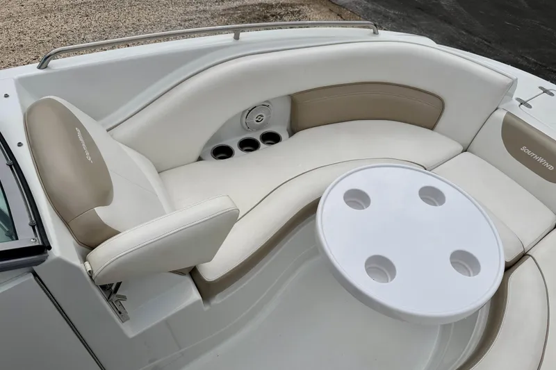 Slide: The Image of 2012 SouthWind 2600 SD boat interior with beige seating and round table. - 12