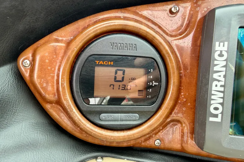 Slide: The Image of Yamaha tachometer on 2012 SouthWind 2600 SD boat dashboard, displaying 713.0 hours. - 16