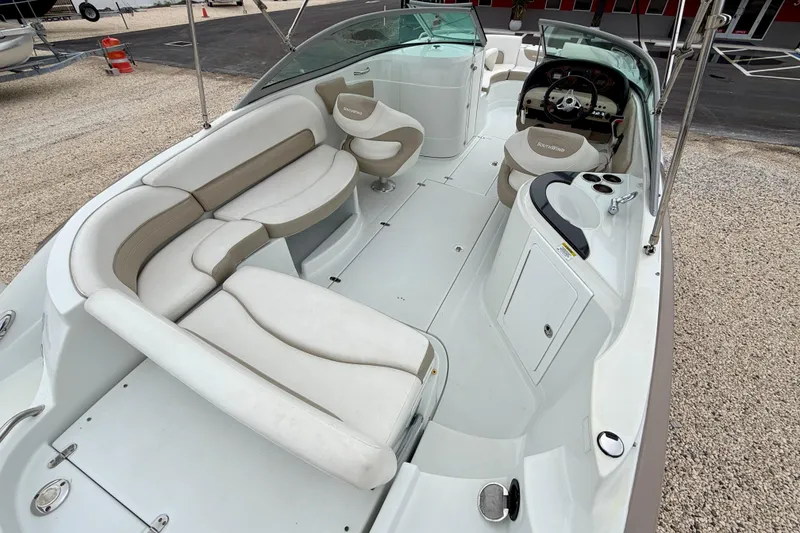 Slide: The Image of 2012 SouthWind 2600 SD boat interior with white seating and steering console. - 23