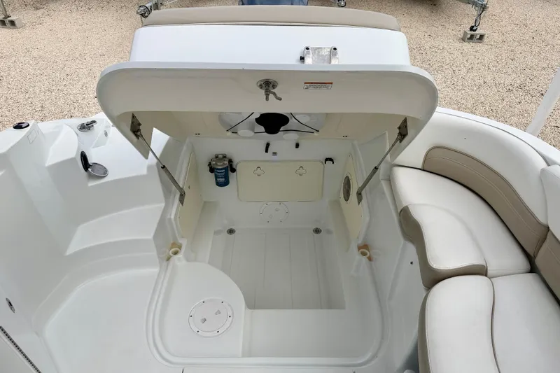 Slide: The Image of 2012 SouthWind 2600 SD boat interior with open storage compartment and seating area. - 26