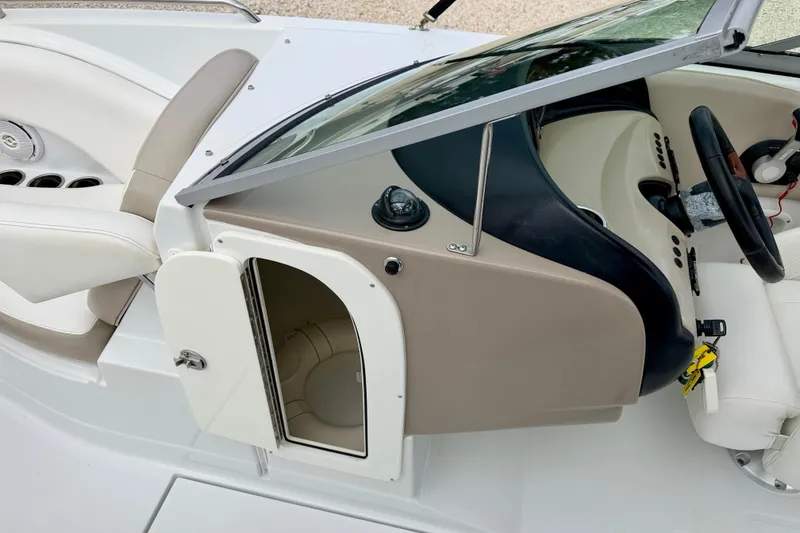 Slide: The Image of 2012 SouthWind 2600 SD boat interior with open storage compartment and steering console. - 27