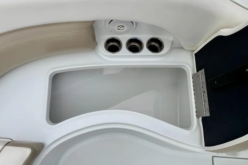 Slide: The Image of 2012 SouthWind 2600 SD boat interior with storage compartment and cup holders. - 32