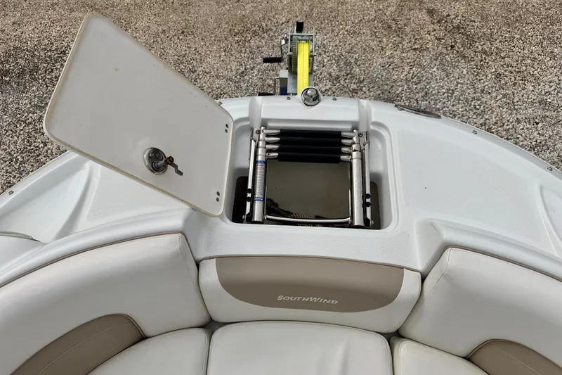 Slide: The Image of 2012 SouthWind 2600 SD boat with open storage compartment and visible ladder. - 34