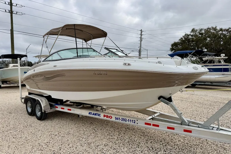 Slide: The Image of 2012 SouthWind 2600 SD boat on trailer, parked outdoors under cloudy sky. - 4
