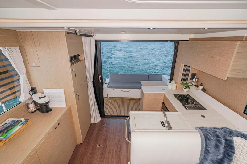 Slide: The Image of Interior of 2025 Beneteau Swift Trawler 41, featuring modern kitchen and ocean view. - 11