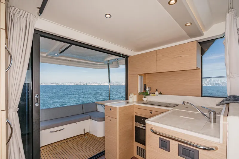 Slide: The Image of Modern kitchen interior on 2025 Beneteau Swift Trawler 41, overlooking ocean view. - 12