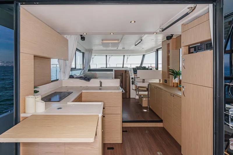 Slide: The Image of Luxurious interior of 2025 Beneteau Swift Trawler 41 with modern kitchen and seating area. - 13