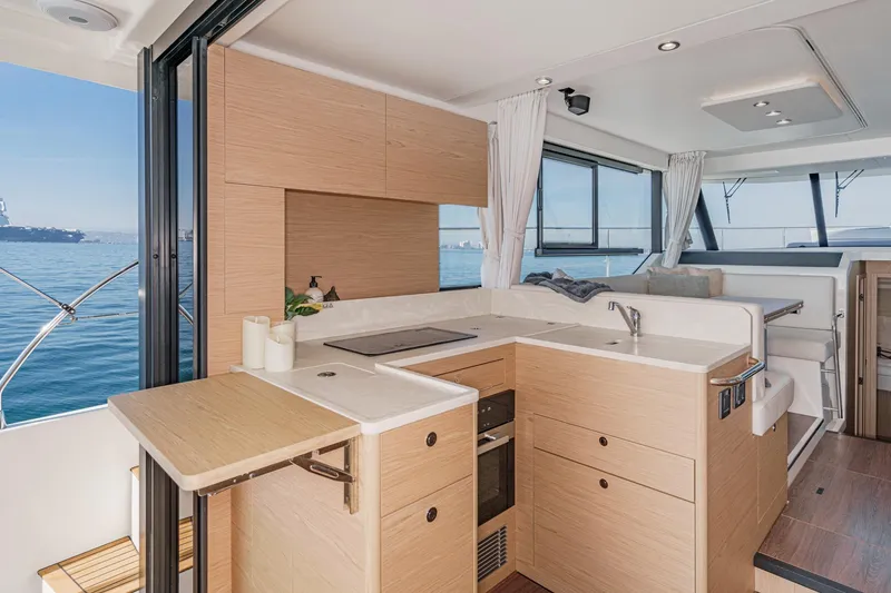 Slide: The Image of Modern interior of 2025 Beneteau Swift Trawler 41 with ocean view and sleek kitchen design. - 14