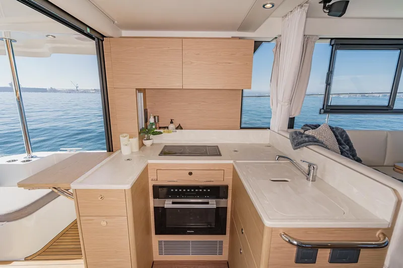 Slide: The Image of Modern kitchen interior on 2025 Beneteau Swift Trawler 41 yacht with ocean view. - 15