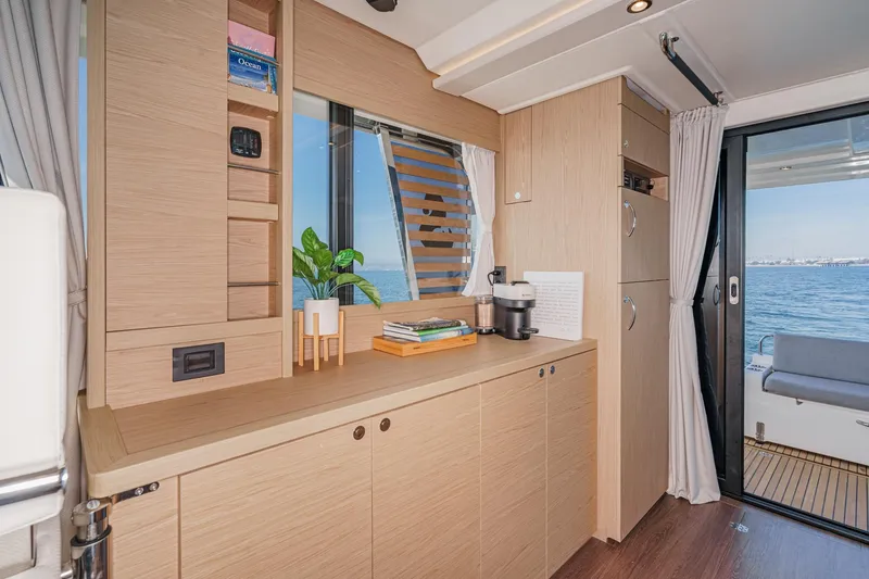 Slide: The Image of Interior of 2025 Beneteau Swift Trawler 41 with modern wood cabinetry and ocean view. - 17
