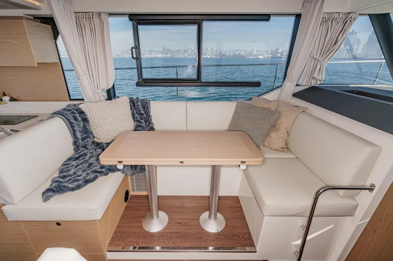 Slide: The Image of Interior of 2025 Beneteau Swift Trawler 41 with cozy seating and ocean view. - 19