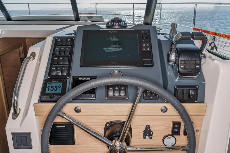 Slide: The Image of 2025 Beneteau Swift Trawler 41 helm with advanced navigation controls and display. - 23