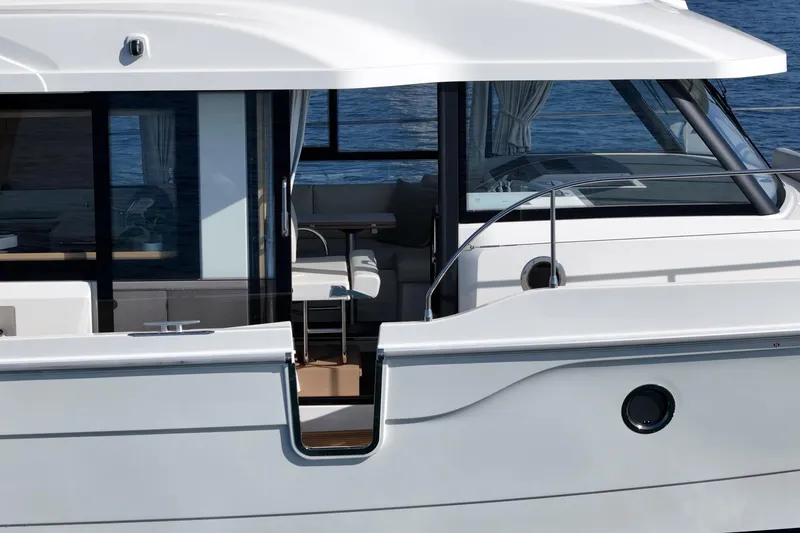 Slide: The Image of 2025 Beneteau Swift Trawler 41, sleek design, modern interior, docked on calm water. - 25