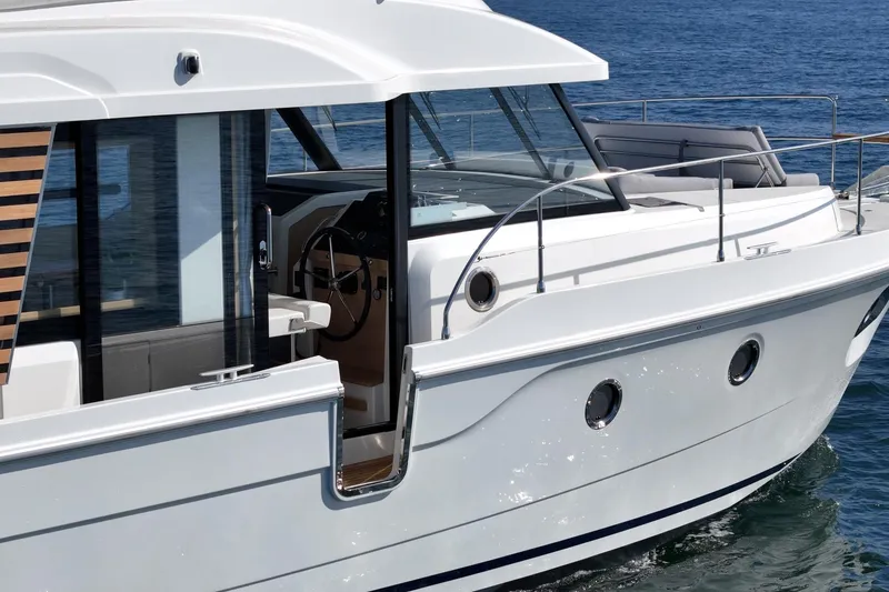 Slide: The Image of 2025 Beneteau Swift Trawler 41 cruising on open water, showcasing sleek design and modern features. - 26