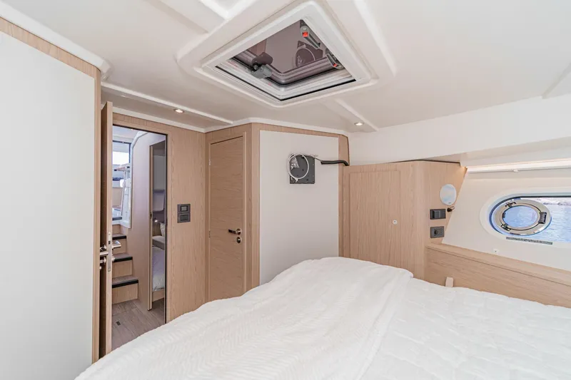 Slide: The Image of 2025 Beneteau Swift Trawler 41 cabin interior with modern design and natural light. - 28