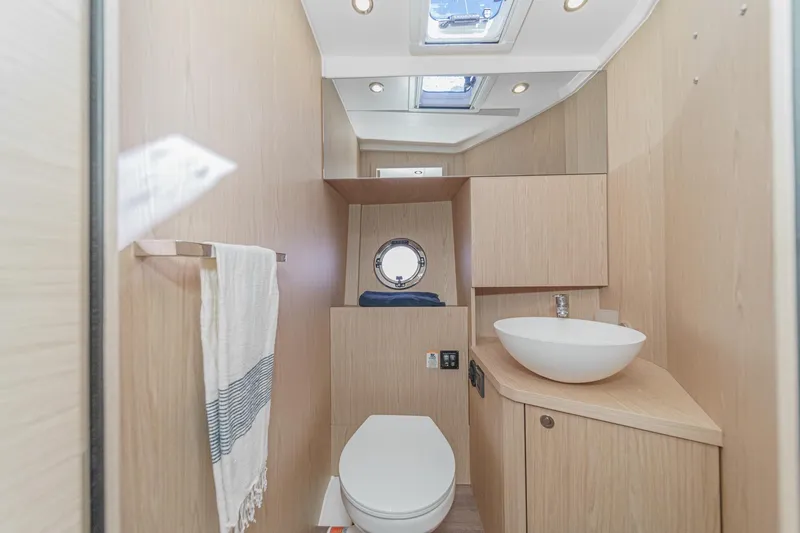 Slide: The Image of Modern bathroom in 2025 Beneteau Swift Trawler 41 with sleek wood finish and skylight. - 30