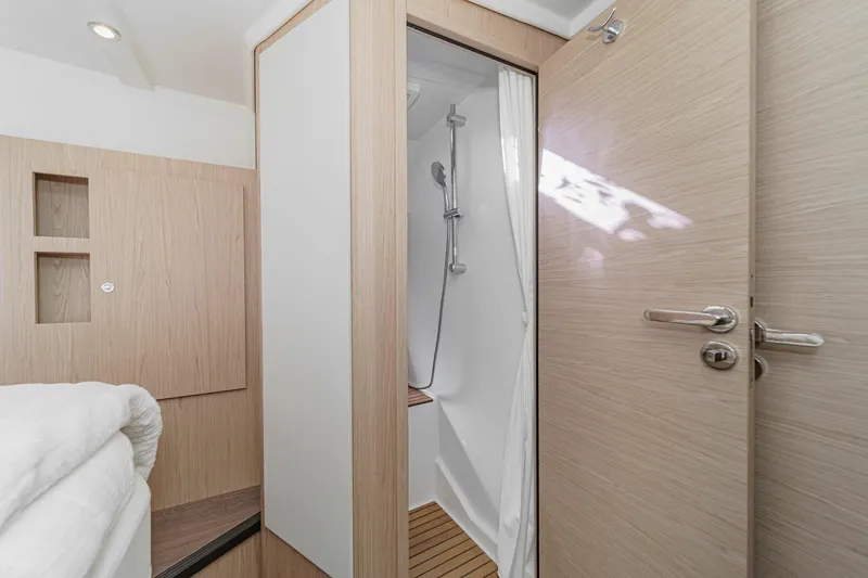 Slide: The Image of 2025 Beneteau Swift Trawler 41 interior shower with modern wood finish. - 31