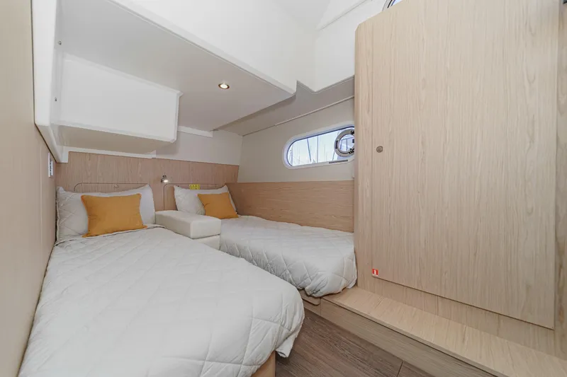 Slide: The Image of 2025 Beneteau Swift Trawler 41 cabin with twin beds and modern wood finish. - 33