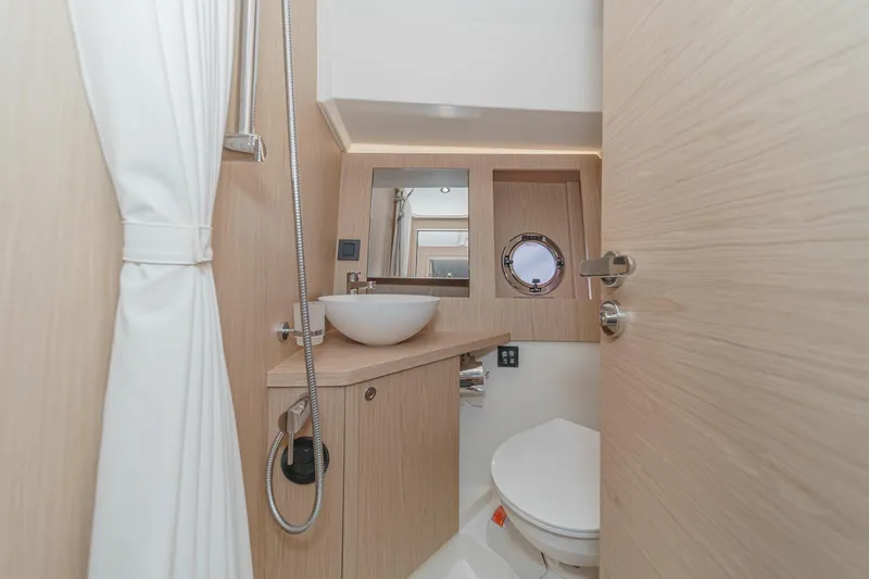 Slide: The Image of Modern bathroom in 2025 Beneteau Swift Trawler 41 with sleek fixtures and porthole window. - 36
