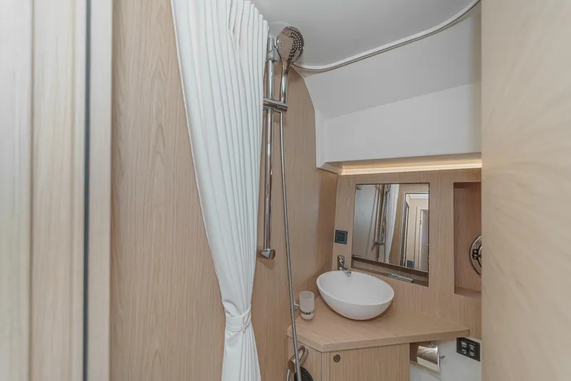 Slide: The Image of Modern bathroom in 2025 Beneteau Swift Trawler 41 with sleek fixtures and wood accents. - 38