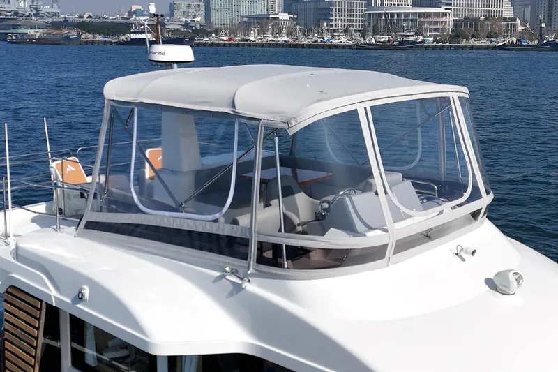 Slide: The Image of 2025 Beneteau Swift Trawler 41 with enclosed flybridge, docked in a marina. - 39