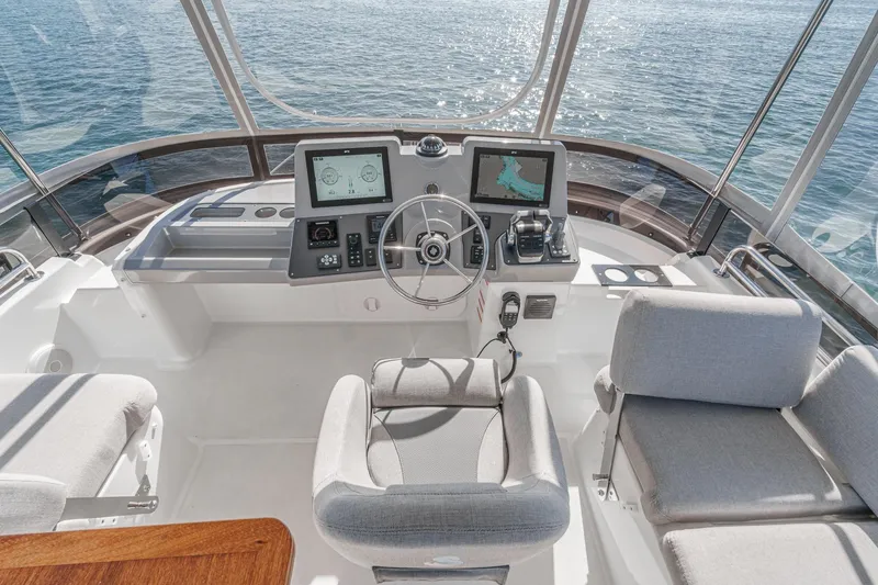 Slide: The Image of 2025 Beneteau Swift Trawler 41 helm with modern navigation systems and ocean view. - 43