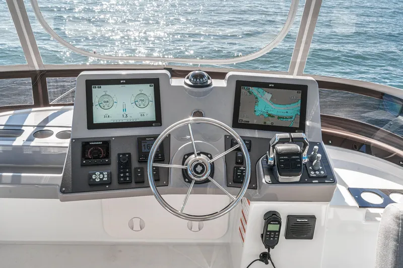 Slide: The Image of 2025 Beneteau Swift Trawler 41 helm with dual displays and navigation controls. - 44
