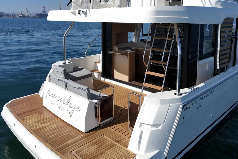 Slide: The Image of 2025 Beneteau Swift Trawler 41, elegant yacht with spacious deck, docked in San Diego. - 5