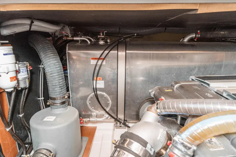 Slide: The Image of Engine room of 2025 Beneteau Swift Trawler 41, showcasing mechanical components and piping. - 53