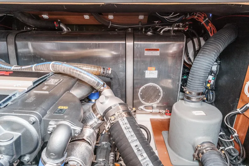 Slide: The Image of Engine room of 2025 Beneteau Swift Trawler 41, showcasing mechanical components and piping. - 54