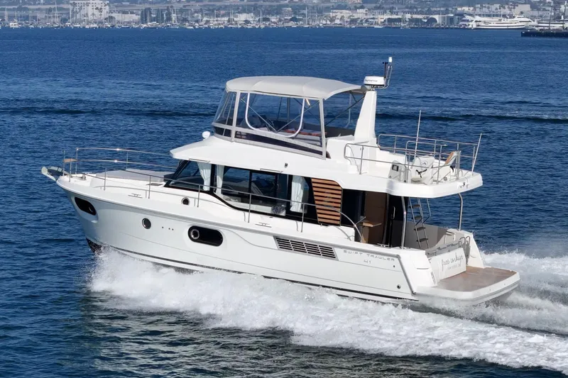 Slide: The Image of 2025 Beneteau Swift Trawler 41 cruising on open water, showcasing sleek design and performance. - 57